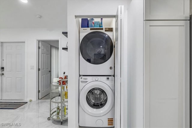 laundry room featuring stacked washing maching and dryer and laundry area