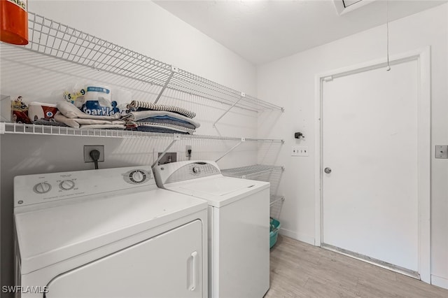 laundry area featuring independent washer and dryer and light wood-type flooring