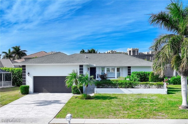 single story home featuring a garage and a front lawn