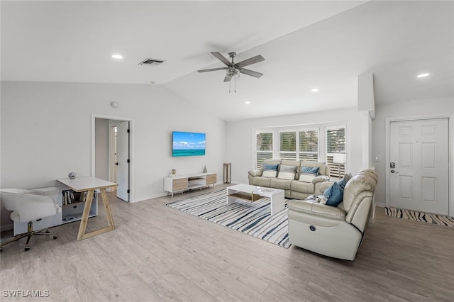 living room with ceiling fan, lofted ceiling, and light wood-type flooring