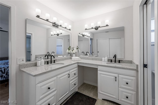 bathroom featuring hardwood / wood-style floors and vanity