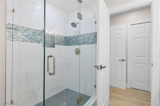 bathroom featuring an enclosed shower and hardwood / wood-style floors