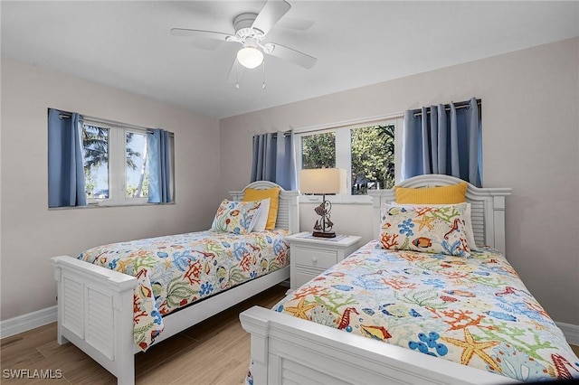 bedroom with ceiling fan and light hardwood / wood-style flooring