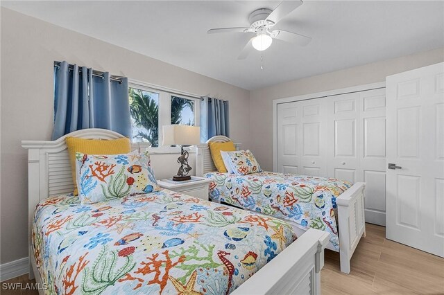 bedroom featuring ceiling fan, a closet, and light hardwood / wood-style flooring