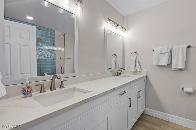 bathroom featuring vanity, wood-type flooring, and an enclosed shower