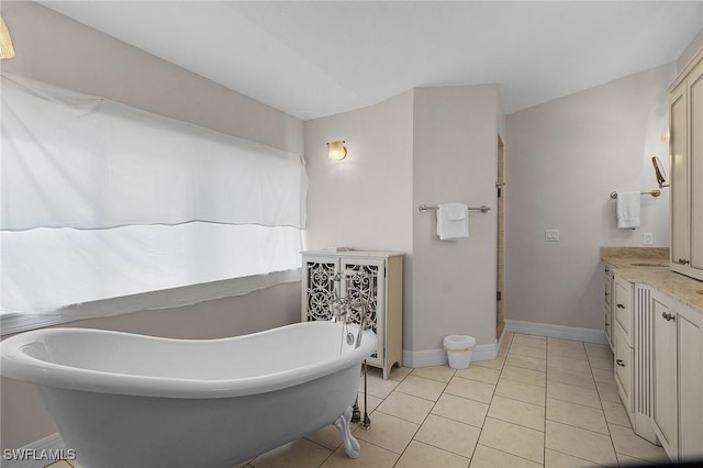 bathroom with vanity, tile patterned flooring, and a washtub