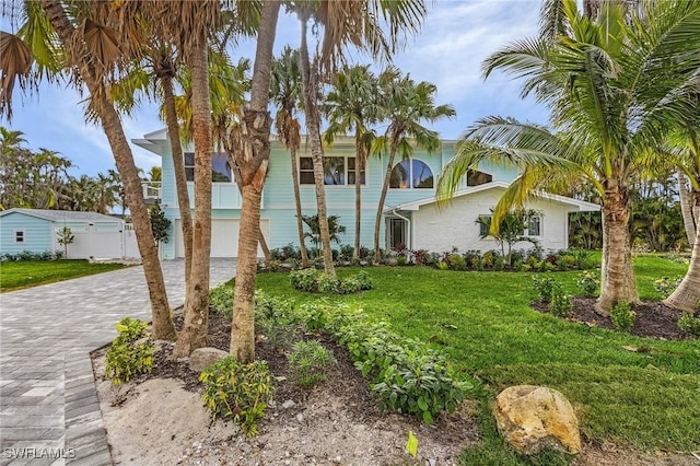 view of front of property with a front lawn and a garage