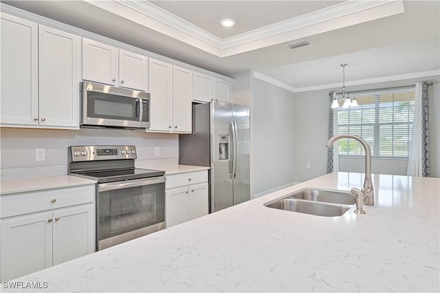 kitchen featuring stainless steel appliances, a chandelier, ornamental molding, white cabinets, and sink