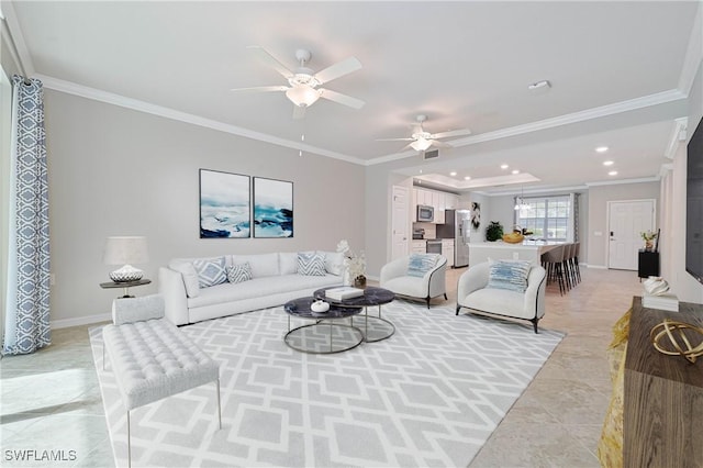 tiled living room with ceiling fan and crown molding