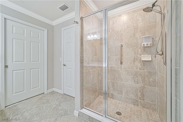 bathroom featuring a shower with shower door, tile patterned floors, and ornamental molding