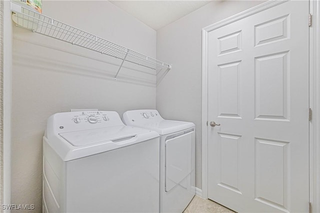 laundry area with washing machine and clothes dryer