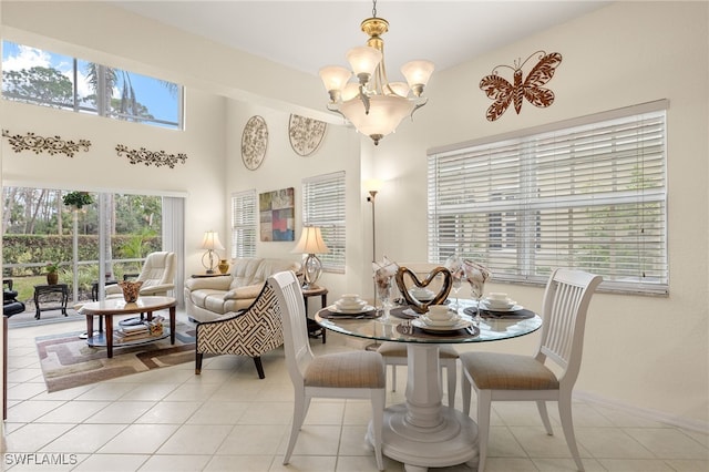 dining room with light tile patterned flooring and a chandelier