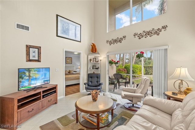 tiled living room featuring a high ceiling