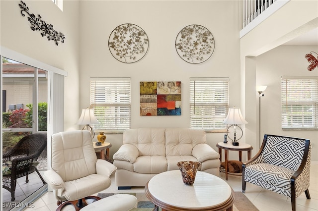 living room with light tile patterned floors and a towering ceiling