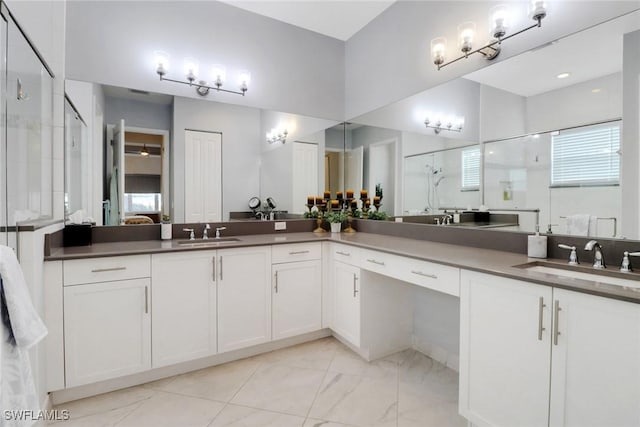 bathroom featuring walk in shower and vanity