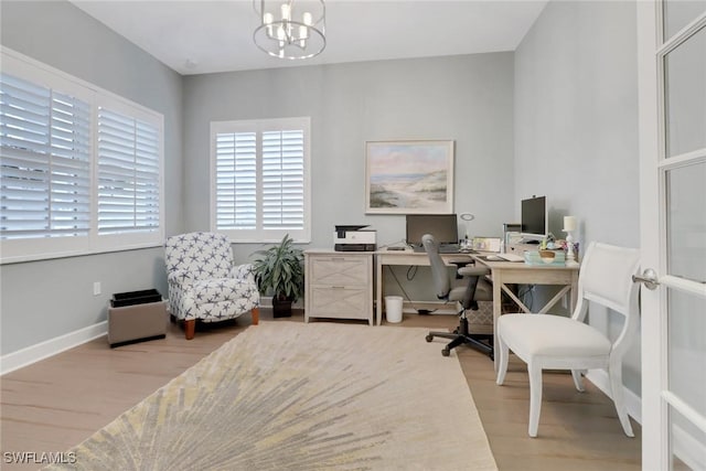 office area with a chandelier and hardwood / wood-style flooring