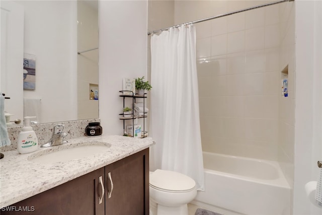 full bathroom featuring toilet, vanity, and shower / bath combo with shower curtain