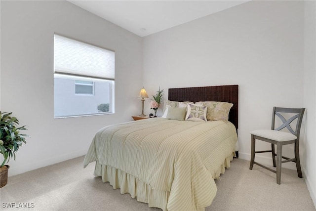 bedroom featuring light colored carpet