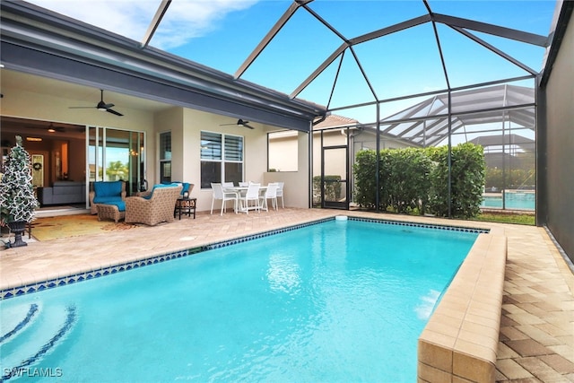 view of pool featuring an outdoor living space, a patio area, and ceiling fan