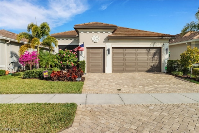 view of front facade with a front yard and a garage