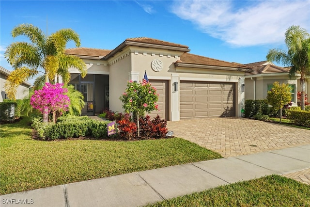 mediterranean / spanish-style house featuring a front lawn and a garage