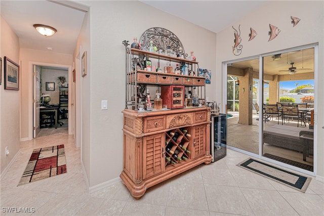 hall with wine cooler and light tile patterned floors