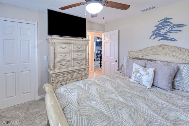 bedroom with ceiling fan, a closet, and light colored carpet