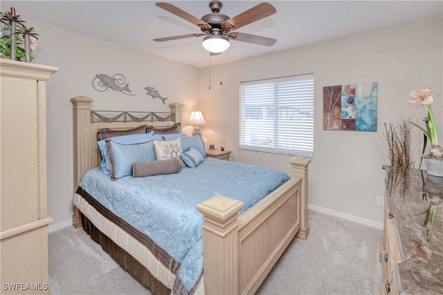 bedroom with ceiling fan and light carpet