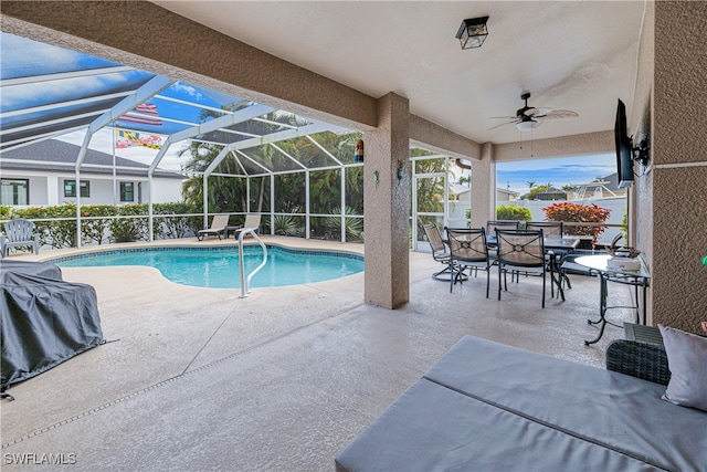 view of swimming pool featuring a lanai and a patio area