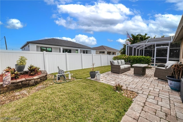 view of yard featuring a patio area, outdoor lounge area, and glass enclosure