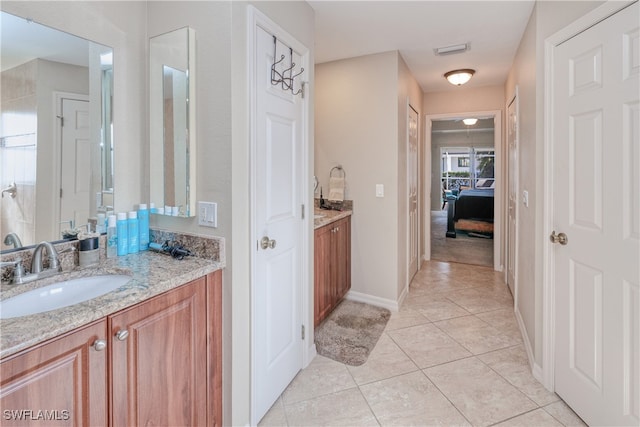 bathroom featuring tile patterned flooring and vanity