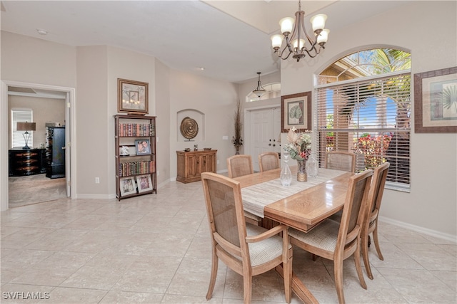 dining area with light tile patterned floors and a notable chandelier