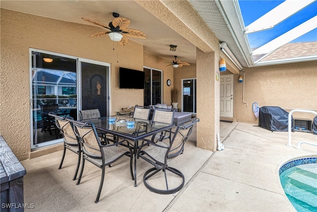 view of patio / terrace with ceiling fan and glass enclosure