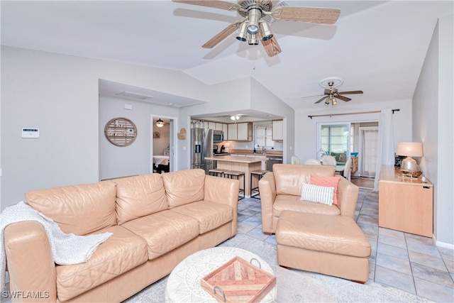 tiled living room featuring lofted ceiling, sink, and ceiling fan