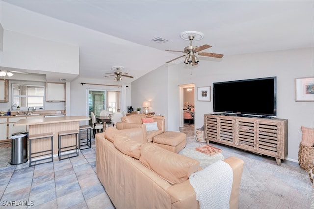 living room featuring sink, vaulted ceiling, and ceiling fan