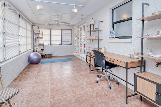 office space featuring lofted ceiling, track lighting, and ceiling fan