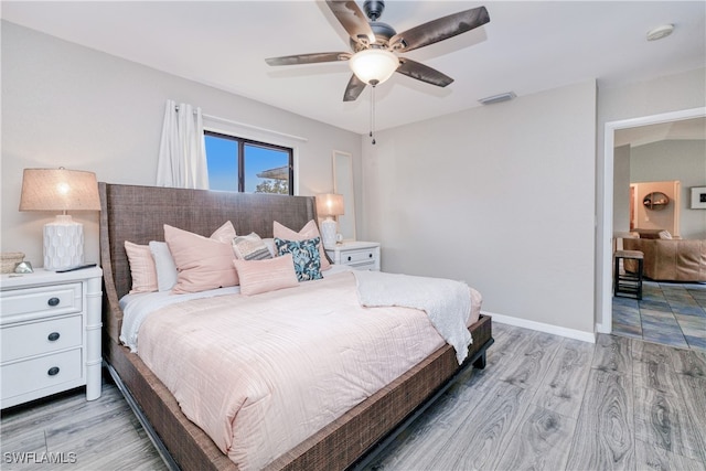 bedroom featuring ceiling fan and light hardwood / wood-style flooring