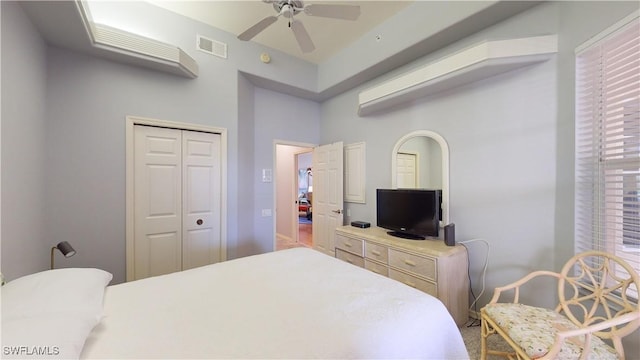 bedroom with ceiling fan and a closet