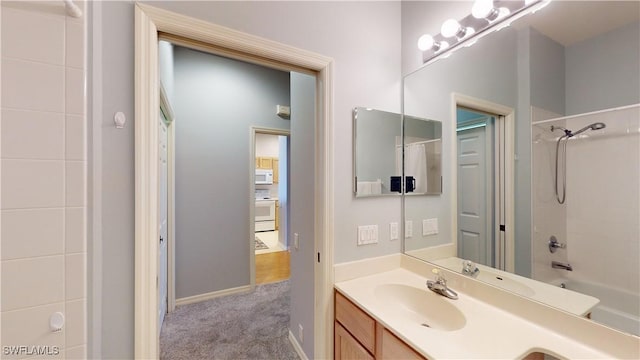 bathroom with vanity and bathing tub / shower combination