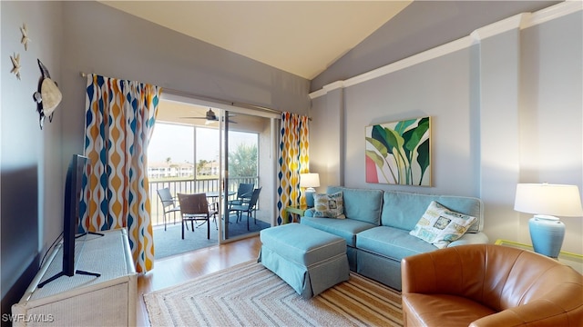 living room featuring ceiling fan, light hardwood / wood-style flooring, and lofted ceiling