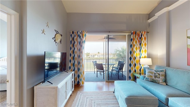 living room featuring ceiling fan and light hardwood / wood-style floors