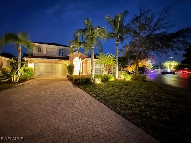 mediterranean / spanish home featuring a garage