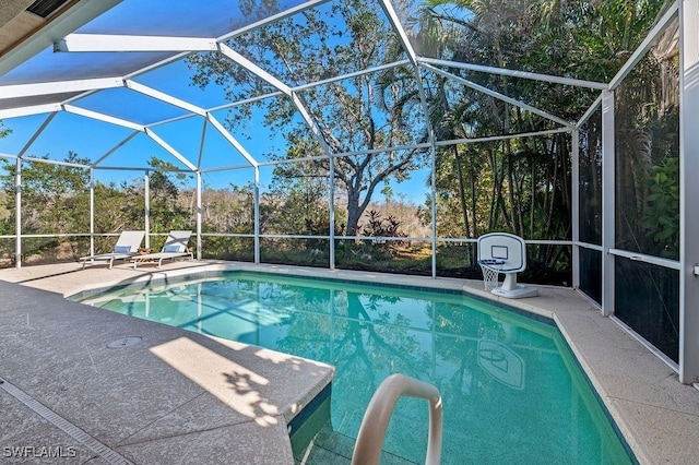 view of swimming pool with a lanai and a patio area