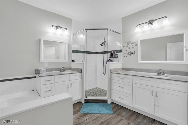 bathroom featuring hardwood / wood-style flooring, vanity, and a shower with door