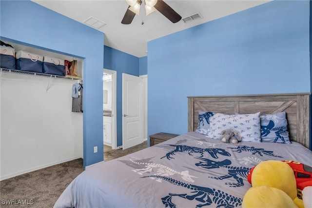 carpeted bedroom featuring ceiling fan and ensuite bath