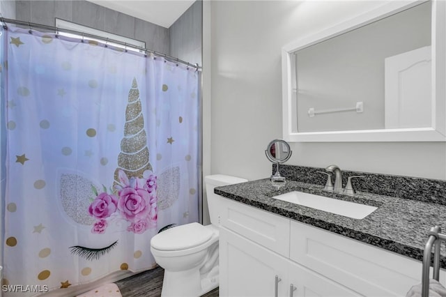 bathroom with vanity, toilet, curtained shower, and wood-type flooring