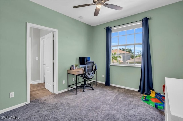 office area featuring light carpet and ceiling fan