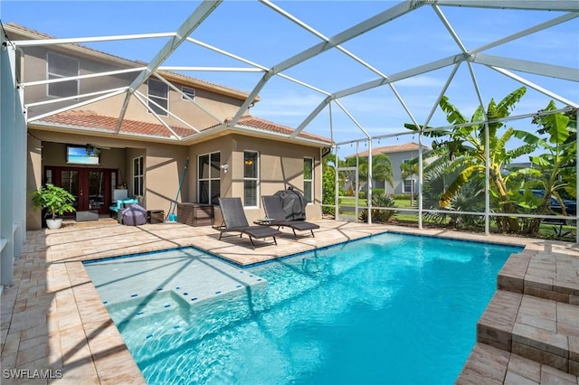 view of swimming pool with glass enclosure, french doors, and a patio