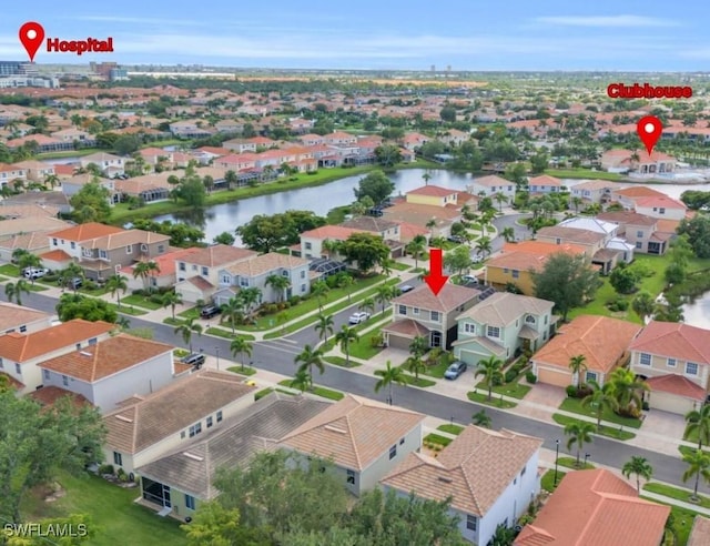 birds eye view of property with a water view