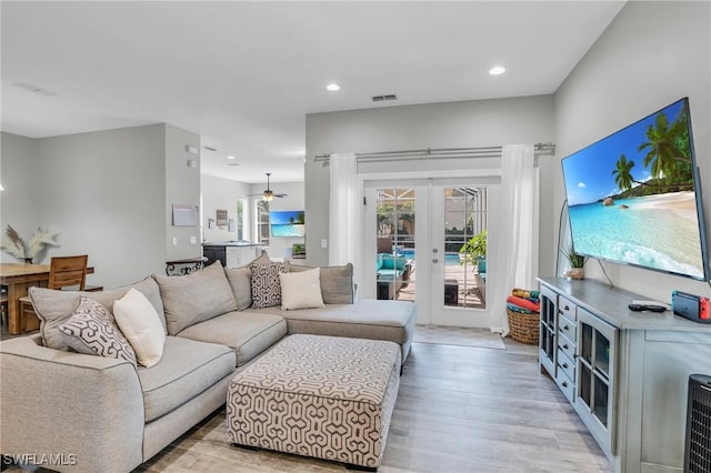 living room featuring light wood-type flooring and french doors